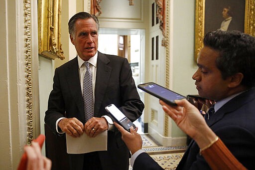 Sen. Mitt Romney, R-Utah, speaks with members of the media as he departs a meeting with Treasury Secretary Steve Mnuchin on an economic lifeline for Americans affected by the coronavirus outbreak on Capitol Hill in Washington, Monday, March 16, 2020. (AP Photo/Patrick Semansky)