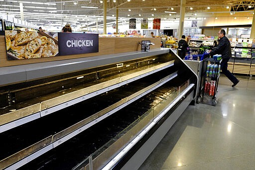 Empty shelves are seen at the Meijer store, Monday, March 16, 2020, in Whitestown, Ind. People concerned with the coronavirus have been shopping ahead and emptying store shelves. (AP Photo/Darron Cummings)