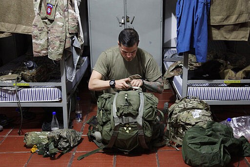 In this Jan. 25, 2020, photo, U.S. Army Sgt. Juan Dominguez prepares his rucksack inside the barracks on Tolemaida Air Base, in Colombia. Dominguez doesn't tell his mother much about what he does as a paratrooper to keep her from worrying. (AP Photo/Sarah Blake Morgan)