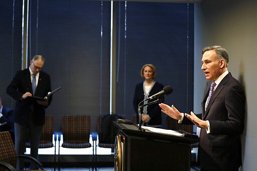 King County Executive Dow Constantine, right, addresses a news conference about the coronavirus outbreak as Washington Gov. Jay Inslee, left, and Seattle Mayor Jenny Durkan maintain &quot;social distancing&quot; Monday, March 16, 2020, in Seattle. Inslee ordered all bars, restaurants, entertainment and recreation facilities to temporarily close to fight the spread of COVID-19 in the state with by far the most deaths in the U.S. from the disease. (AP Photo/Elaine Thompson, Pool)