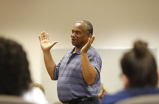 In this, Wednesday, Feb. 12, 2020 photo, Vincent Keeys, standing, president of the NAACP in Collier County, talks to a group of nonprofit leaders and government agencies about the Census undercount in 2010, in Immokalee, Fla. &quot;In 2010, we had a lot of money on the table that was just lost and didn't come to the community. It is so critically important,&quot; said Keeys. Small, poor and largely Latino communities around the U.S. historically have been undercounted, an analysis by The Associated Press shows, posing challenges for Census workers in a tally that's supposed to ensure federal dollars get to communities needing them most. (AP Photo/Wilfredo Lee)