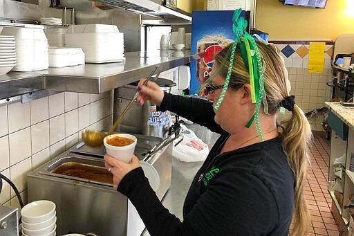 Danielle Livingston fills a soup order at Earl's Diner in Ferndale, Mich., Monday, March 16, 2020. Livingston said a ban on serving meals inside restaurants will cut her tips. &quot;Who's going to come in for carry-outs? Not a lot of people tip on carry-outs,&quot; she said. (AP Photo/Ed White)