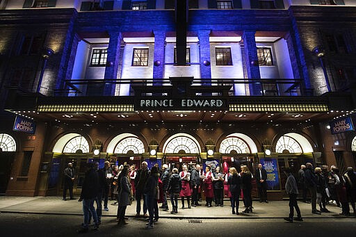 Staff from The Prince Edward Theatre in London, inform theatregoers that all performances are cancelled because of the threat of COVID-19 virus, Monday March 16, 2020. Prime Minister Boris Johnson said Monday that &#147;now is the time for everyone to stop non-essential contact with others and to stop all unnecessary travel.&#148; saying people should &quot;avoid pubs, clubs, theatres and other such social venues.&quot; For most people, the coronavirus causes only mild or moderate symptoms, but for some it can cause a more severe illness, especially in older adults and people with pre-existing health problems. (Aaron Chown/PA via AP)