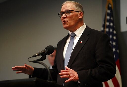 Washington Gov. Jay Inslee talks at a news conference about the coronavirus outbreak in downtown Seattle, Monday, March 16, 2020. (Erika Schultz/The Seattle Times via AP)