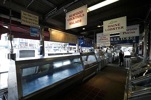 A number of crab and seafood stands are seen closed at Fisherman's Wharf Monday, March 16, 2020, in San Francisco. Officials in six San Francisco Bay Area counties issued a shelter-in-place mandate Monday affecting nearly 7 million people, including the city of San Francisco itself. The order says residents must stay inside and venture out only for necessities for three weeks starting Tuesday in a desperate attempt by officials to curb the spread of the novel coronavirus. (AP Photo/Eric Risberg)