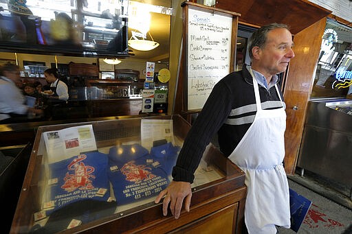 Tom La Torre waits to seat customers while standing outside his Sabella &amp; LaTorre restaurant at Fisherman's Wharf Monday, March 16, 2020, in San Francisco. Officials in six San Francisco Bay Area counties issued a shelter-in-place mandate Monday affecting nearly 7 million people, including the city of San Francisco itself. The order says residents must stay inside and venture out only for necessities for three weeks starting Tuesday in a desperate attempt by officials to curb the spread of the novel coronavirus. (AP Photo/Eric Risberg)