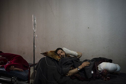 In this Thursday, March 12, 2020 photo, Abdullah Alhassan, 50, who lost both legs after stepping on a landmine, recovers in Idlib central hospital, Syria. Idlib city is the last urban area still under opposition control in Syria, located in a shrinking rebel enclave in the northwestern province of the same name. Syria&#146;s civil war, which entered its 10th year Monday, March 15, 2020, has shrunk in geographical scope -- focusing on this corner of the country -- but the misery wreaked by the conflict has not diminished. (AP Photo/Felipe Dana)