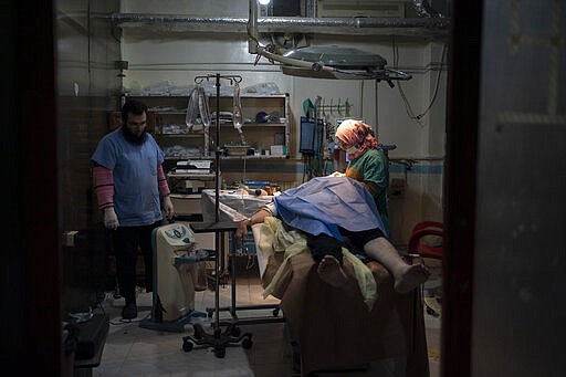 In this Thursday, March 12, 2020 photo, a patient is prepared for surgery at Idlib central hospital in Idlib, Syria. Idlib city is the last urban area still under opposition control in Syria, located in a shrinking rebel enclave in the northwestern province of the same name. Syria&#146;s civil war, which entered its 10th year Monday, March 15, 2020, has shrunk in geographical scope -- focusing on this corner of the country -- but the misery wreaked by the conflict has not diminished. (AP Photo/Felipe Dana)