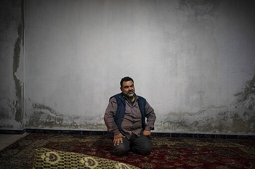 In this Thursday, March 12, 2020 photo, Yasser Alaboud, 45, poses for a photo inside his new home, in Idlib, Syria. Idlib city is the last urban area still under opposition control in Syria, located in a shrinking rebel enclave in the northwestern province of the same name. Syria&#146;s civil war, which entered its 10th year Monday, March 15, 2020, has shrunk in geographical scope -- focusing on this corner of the country -- but the misery wreaked by the conflict has not diminished. (AP Photo/Felipe Dana)