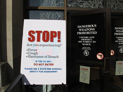 The Louisiana Capitol is limiting access to the public because of the coronavirus epidemic, taking temperatures to ensure people entering the building don't have a fever and asking questions about symptoms, on Monday, March 16, 2020, in Baton Rouge, La. (AP Photo/Melinda Deslatte)