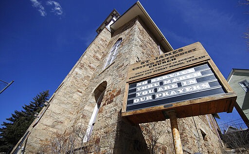 The sign outside St. James United Methodist Church announces that srvices are discontinued through month's end as nearby casinos were shuttered to the public in the state's efforts to fend off the spread of coronavirus Tuesday, March 17, 2020, in Central City, Colo. According to the World Health Organization, most people recover in about two to six weeks depending on the severity of the illness. (AP Photo/David Zalubowski)