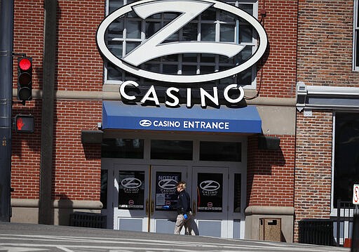 Jennifer Hotkz, an investigator with the Colorado Gaming Department, checks that doors are locked to a casino which has been closed to the public in the state's efforts to fend off the spread of coronavirus Tuesday, March 17, 2020, in Black Hawk, Colo. According to the World Health Organization, most people recover in about two to six weeks depending on the severity of the illness. (AP Photo/David Zalubowski)