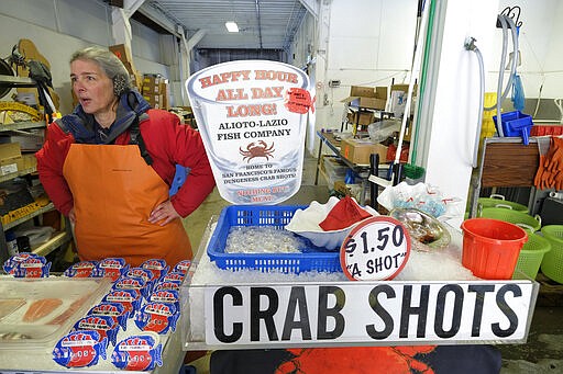 Angel Cincotta, co-owner of the Alioto-Lazio Fish Company, talks about how she plans to stay open at Fisherman's Wharf Monday, March 16, 2020, in San Francisco. Officials in six San Francisco Bay Area counties issued a shelter-in-place mandate Monday affecting nearly 7 million people, including the city of San Francisco itself. The order says residents must stay inside and venture out only for necessities for three weeks starting Tuesday in a desperate attempt by officials to curb the spread of the novel coronavirus. (AP Photo/Eric Risberg)