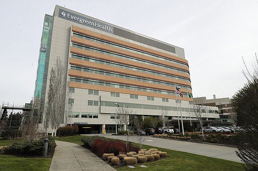 EvergreenHealth Medical Center is shown Tuesday, March 17, 2020, in Kirkland, Wash., near Seattle. In the area that has led the country in coronavirus cases and also across the country, hospitals are gearing up for an onslaught of coronavirus patients, but staff on the front lines are stretched thin and don't have the equipment they need to protect themselves from the highly contagious virus. (AP Photo/Ted S. Warren)