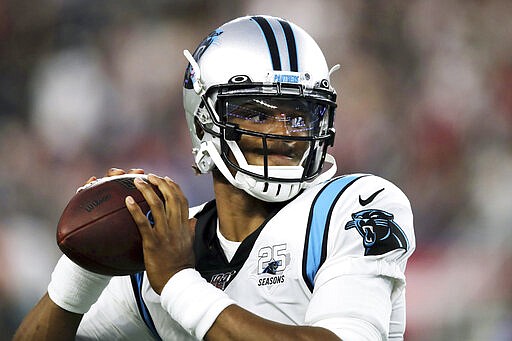 FILE - In this Aug. 22, 2019, file photo, Carolina Panthers quarterback Cam Newton warms up before an NFL preseason football game against the New England Patriots in Foxborough, Mass. While Newton remains optimistic about his chances of playing for the Panthers next season, the team is remaining mostly silent on the quarterback's future. (AP Photo/Charles Krupa, File)