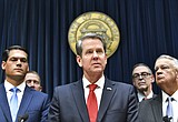 Kemp signs amended Georgia budget, $100 million for virus