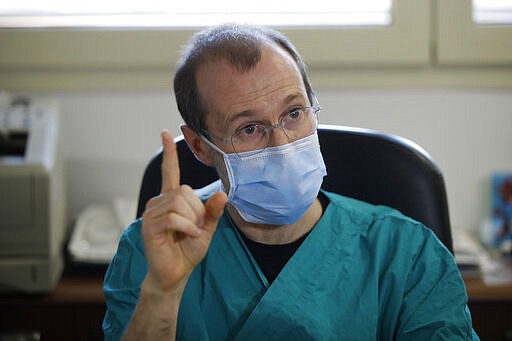 In this March 16, 2020, photo, Sergio Cattaneo, head of anesthesiology and intensive care at Brescia Ospedali Civili hospital, talks with The Associated Press about the coronavirus, in Brescia, Italy. &quot;What is really shocking &#151; something we had not been able to forecast and brought us to our knees &#151; is the quickness the epidemic spreads,&#148; Cattaneo said. &quot;If the spreading of this epidemic is not put under control, it will bring all hospitals to their knees.&quot; (AP Photo/Luca Bruno)