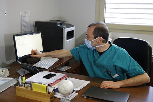 In this March 16, 2020, photo, Sergio Cattaneo, head of anesthesiology and intensive care at Brescia Ospedali Civili hospital, talks with The Associated Press about the coronavirus, in Brescia, Italy. &quot;What is really shocking &#151; something we had not been able to forecast and brought us to our knees &#151; is the quickness the epidemic spreads,&#148; Cattaneo said. &quot;If the spreading of this epidemic is not put under control, it will bring all hospitals to their knees.&quot; (AP Photo/Luca Bruno)