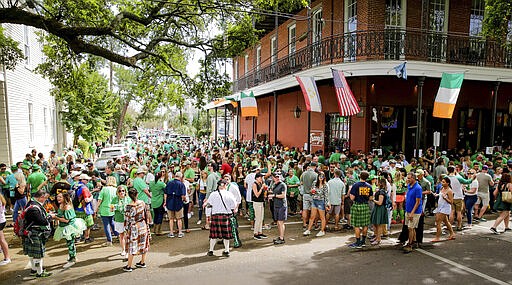 Revelers celebrate St. Patrick's Day Saturday, March 14, 2020, during an unofficial gathering at Tracey's Original Irish Channel Bar in New Orleans.  (Scott Threlkeld/The Advocate via AP)