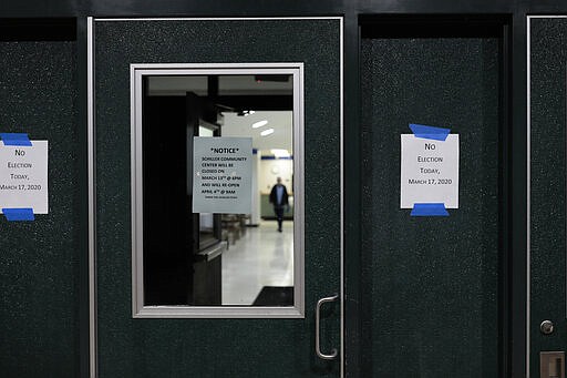 A sign alerts voters that polls are closed for a scheduled primary election on Tuesday, March 17, 2020, at Schiller Recreation Center in Columbus, Ohio. Ohio called off its presidential primary just hours before polls were set to open there and in three other states, an 11th-hour decision the governor said was necessary to prevent further fueling the coronavirus pandemic that has paralyzed the nation. (Joshua A. Bickel/The Columbus Dispatch via AP)