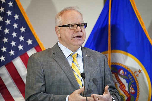 Minnesota Gov. Tim Walz speaks during a news conference about the outbreak of Coronavirus in St. Paul, Minn., Monday, March 16, 2020. Walz ordered bars and restaurants across Minnesota to temporarily close to customers who dine in amid fears of coronavirus cases. (Glen Stubbe/Star Tribune via AP)