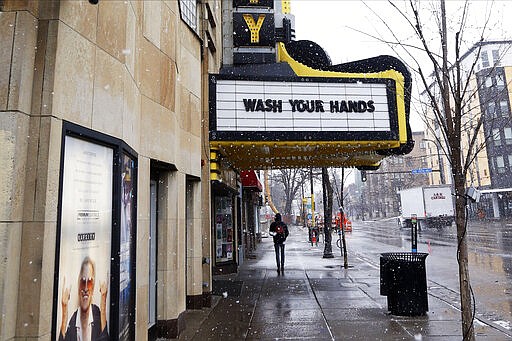 The Varsity Theater, home to concerts, used the marquee to address the need for washing hands due to the coronavirus, the disease that is caused by the new coronavirus, Monday, March 16, 2020 near the University of Minnesota in Minneapolis. (AP Photo/Jim Mone)