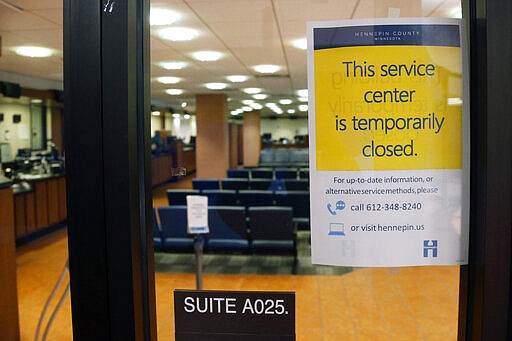 The Hennepin County Government Center service center stands closed Tuesday, March 17, 2020 in Minneapolis where efforts to slow the spread of the coronavirus continue. (AP Photo/Jim Mone)