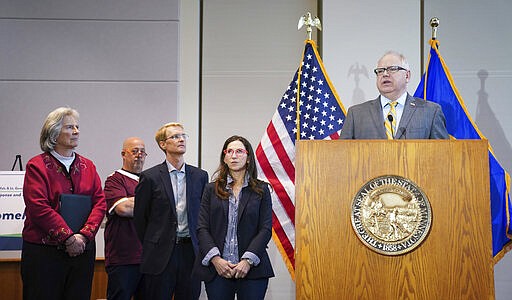 Minnesota Gov. Tim Walz speaks during a news conference in St. Paul, Minn., Monday, March 16, 2020. Walz ordered bars and restaurants across Minnesota to temporarily close to customers who dine in amid fears of coronavirus cases. He is with MDH Commissioner Jan Malcolm, Employment Commissioner Steve Grove, Restaurant owners Andrew Zimmern, Stephanie Shimp of the Blue Plate and John Puckett of Punch Pizza. (Glen Stubbe/Star Tribune via AP)