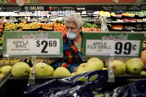 Carmen Zamora shops at Northgate Gonz&aacute;lez Market on Tuesday, March 17, 2020, in Santa Ana, Calif. In light of the coronavirus concerns the Northgate market chain opened it's stores one hour early for seniors 65-years and older and disabled. (AP Photo/Chris Carlson)