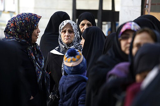 FILE &#151; In this Feb. 21, 2020 file photo, Iranians line up for voting in the parliamentary elections at a polling station in Tehran, Iran. Nine out of 10 cases of the virus in the Middle East come from the Islamic Republic. Days of denials gave the virus time to spread as the country marked the 41st anniversary of its 1979 Islamic Revolution. Iran also held a parliamentary election in which authorities desperately sought to boost turnout. For most people, the new coronavirus causes only mild or moderate symptoms. For some it can cause more severe illness. (AP Photo/Vahid Salemi, File)