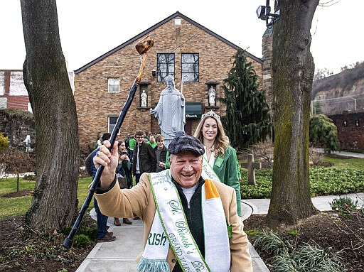 Tim Finnerty, the Grand Marshall of this year's St. Patrick's Day parade, leads congregants out of the Feast of St. Patrick Mass at Old Saint Patrick's Church in the Strip District in Pittsburgh on Saturday, March 14, 2020. &quot;I'd rather be known as the grand marshall of the parade that was canceled rather than the grand marshal that maybe spread the coronavirus,&quot; Finnerty said. The parade was cancelled by the city due to COVID-19 precautions. (Steph Chambers/Pittsburgh Post-Gazette via AP)