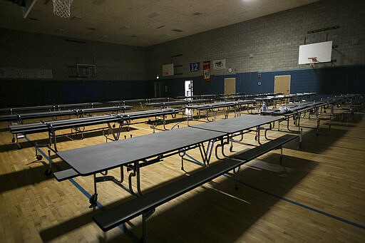 An empty gymnasium is viewed at Robertson Elementary School, Monday, March 16, 2020, in Yakima, Wash. All 15 Yakima County school districts announced they are canceling classes because of the coronavirus outbreak starting Monday. (Amanda Ray/Yakima Herald-Republic via AP)