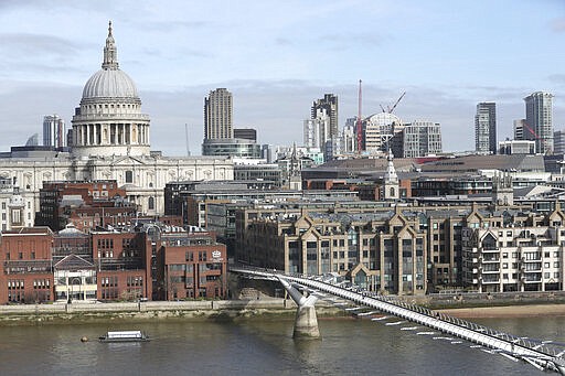 People cross the Millennium Bridge in London, Tuesday March 17, 2020. British authorities ramped up public health measures Monday, telling people who are in the groups considered most vulnerable to severe COVID-19 illness to stay at home for three months. For most people, the virus causes only mild or moderate symptoms, such as fever and cough. For some, especially older adults and people with existing health problems, it can cause more severe illness, including pneumonia. (Jonathan Brady/PA via AP)