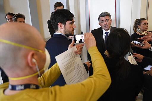 Sen. Cory Gardner, R-Colo., talks with reporters as he heads to the weekly Republican policy lunch on Capitol Hill in Washington, Tuesday, March 17, 2020. (AP Photo/Susan Walsh)