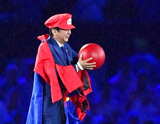 FILE - In this Aug. 21, 2016, file photo, Japanese Prime Minister Shinzo Abe appears as the Nintendo game character Super Mario during the closing ceremony at the 2016 Summer Olympics in Rio de Janeiro, Brazil. Prime Minister Abe might be the biggest loser if the Tokyo Olympics don't go off as planned in just over four months. Abe has attached himself to the success of the Olympics since pushing hard for Tokyo's selection at an IOC meeting in 2013 in Buenos Aires, Argentina. Tokyo was picked over Istanbul by billing itself as a &#147;safe pair of hands.&quot;  (Yu Nakajima/Kyodo News via AP, File)