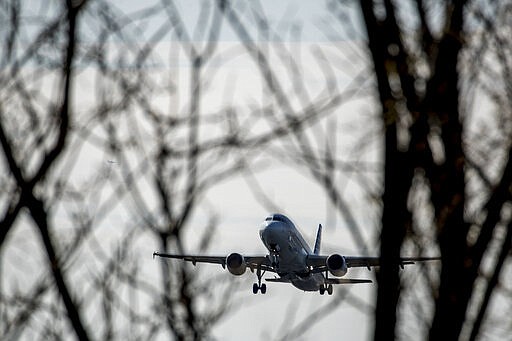 A plane takes off from Ronald Reagan Washington National Airport, Monday, March 16, 2020, in Arlington, Va. (AP Photo/Andrew Harnik)