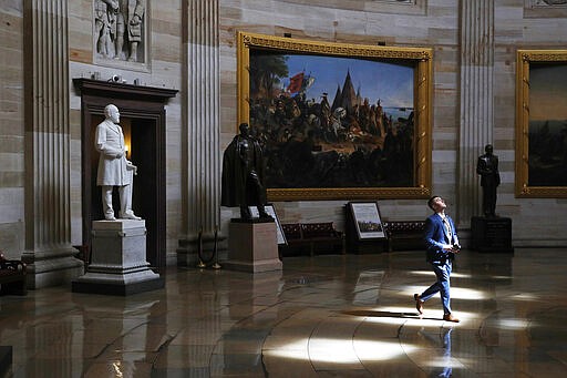 A man walks through an empty U.S. Capitol Rotunda on Capitol Hill in Washington, Monday, March 16, 2020. Congress has shut the Capitol and all Senate and House office buildings to the public until April in reaction to the spread of the coronavirus outbreak. (AP Photo/Patrick Semansky)