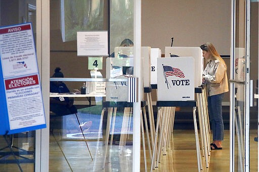 Voters cast their ballots for the Florida presidential primary, Tuesday, March 17, 2020, in Bonita Springs, Fla. Floridians are voting across the state as election officials manage losses of poll workers and changes to polling places because of the coronavirus.  (AP Photo/Elise Amendola)