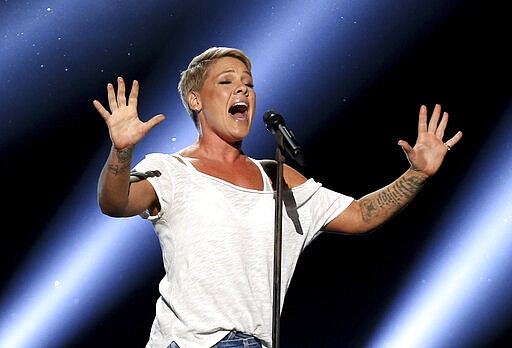 FILE - In this Jan. 28, 2018, file photo, Pink performs &quot;Wild Hearts Can't Be Broken&quot; at the 60th annual Grammy Awards at Madison Square Garden in New York. The spreading coronavirus might have canceled several touring performances from A-list musical artists, but those acts have found a new venue to sing: their living rooms. Pink, John Legend, Bono, Coldplay&#146;s Chris Martin, John Mayer, Keith Urban and others have held virtual concerts from their homes as the world continues to practice social distancing to slow the spread of the virus. (Photo by Matt Sayles/Invision/AP, File)