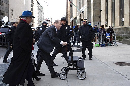 FILE - In this Feb. 20, 2020 file photo, Harvey Weinstein, center, arrives at a Manhattan court as jury deliberations continue in his rape trial in New York. Weinstein was transferred to a state prison in New York on Wednesday, March 18, as he begins to serve a 23-year sentence for rape and sexual assault in his landmark #MeToo case. (AP Photo/Mark Lennihan, File)