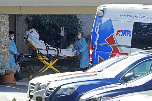 A patient is loaded into an ambulance at the Life Care Center in Kirkland, Wash. Monday, March 9, 2020, near Seattle. The nursing home is at the center of the outbreak of the COVID-19 coronavirus in Washington state. (AP Photo/Ted S. Warren)