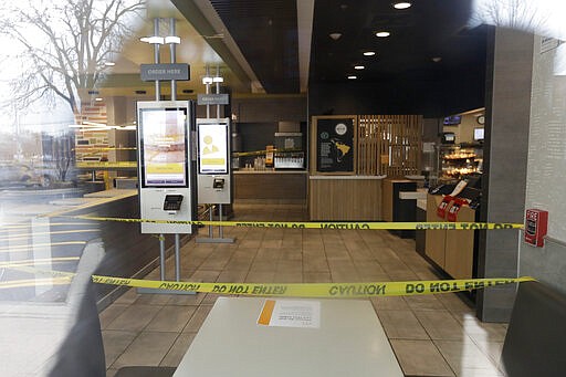 The closed off seating area inside a McDonald's restaurant in Arlington Heights, Ill., Wednesday, March 18, 2020. All bars and restaurants in the state to have closed their dining rooms through March 30 due to coronavirus concerns. (AP Photo/Nam Y. Huh)