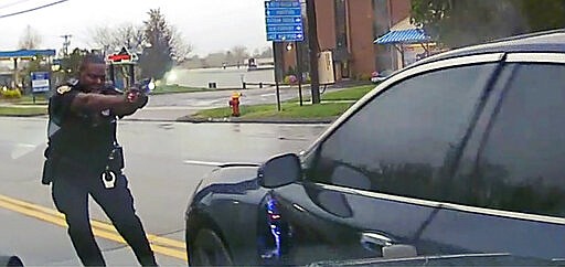 FILE - This May 3, 2019 file photo, a still image from police dash camera video, released by the Hartford State's Attorney, shows Police Officer Layau Eulizier pointing his weapon at a car being driven at him by Anthony Jose Vega Cruz during an attempted traffic stop April 20, 2019, in Wethersfield, Conn.  Eulizier who fatally shot the 18-year-old after running in front of his car and firing through the windshield was justified in using deadly force, a state prosecutor announced Wednesday, March 18, 2020. (Hartford State's Attorney via AP, File)