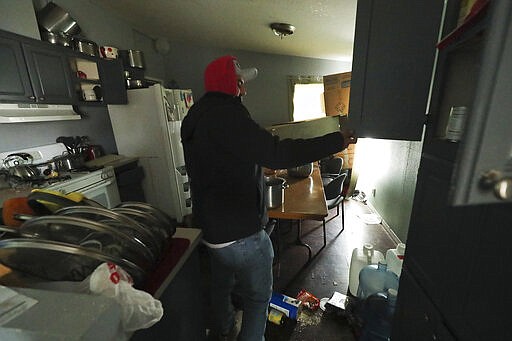 Israel Garcia looks over damage to his mobile home after a  earthquake in Salt Lake City on Wednesday, March 18, 2020. A 5.7-magnitude earthquake has shaken Salt Lake City and many of its suburbs. The quake sent panicked residents running to the streets, knocked out power to tens of thousands of homes and closed the city's airport and its light rail system.  (Jeffrey D. Allred/The Deseret News via AP)