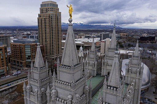 This Wednesday, March 18, 2020 photo shows the Angel Moroni statue atop the Salt Lake Temple of The Church of Jesus Christ of Latter-day Saints in Salt Lake City. An earthquake shook millions of people across metro Salt Lake City Wednesday, closing a major international airport hub, showering bricks onto sidewalks and damaging a spire and statue atop the Church of Jesus Christ of Latter-day Saints'  iconic Salt Lake Temple.  (Spenser Heaps/The Deseret News via AP)