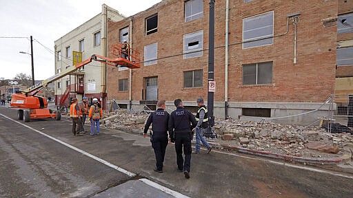 Police officers walk pass rubble after an earthquake Wednesday, March 18, 2020, in Salt Lake City.   A 5.7-magnitude earthquake has shaken the city and many of its suburbs. The quake sent panicked residents running to the streets, knocked out power to tens of thousands of homes and closed the city's airport and its light rail system.&#160;  (AP Photo/Rick Bowmer)