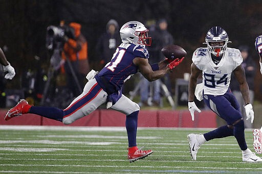 FILE - In this Jan. 4, 2020, file photo, New England Patriots safety Duron Harmon, left, intercepts a pass in front of Tennessee Titans wide receiver Corey Davis in the second half of an NFL wild-card playoff football game, in Foxborough, Mass. The New England Patriots have agreed to trade safety Duron Harmon to the Detroit Lions, according to a person with knowledge of the deal. The person spoke on condition of anonymity Wednesday, March 18, 2020, because the trade had not been announced.(AP Photo/Elise Amendola, File)