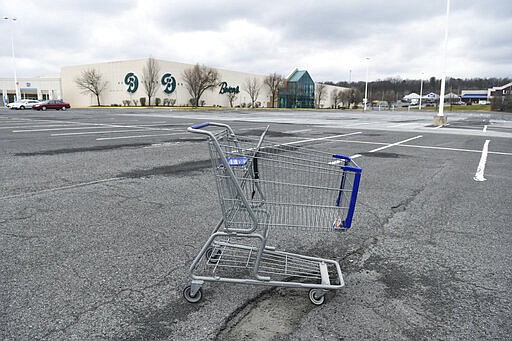 In this Tuesday, March 17, 2020, photo, a lone shopping cart sits in an empty parking lot near a shopping mall closed due to coronavirus concerns in Pottsville, Pa. In Pennsylvania last week, 12,200 people filed for unemployment insurance. In just a single day this week, that number exploded beyond 50,000. In neighboring Ohio, 48,460 people filed for unemployment Sunday and Monday, compared to less than 1,900 over the same period the week before. It&#146;s the same story in state after state, as millions of displaced Americans lose their jobs amid the widening shutdowns to contain the coronavirus. (Jacqueline Dormer/Republican-Herald via AP)