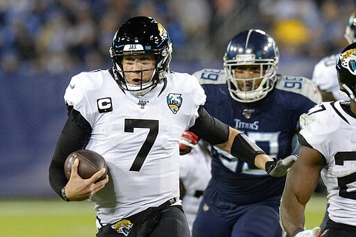 FLE - In this Nov. 24, 2019, file photo, Jacksonville Jaguars quarterback Nick Foles (7) scrambles against the Tennessee Titans in the second half of an NFL football game in Nashville, Tenn. A person familiar with the trade says the Jacksonville Jaguars have agreed to send quarterback Nick Foles to the Chicago Bears for a compensatory fourth-round draft pick. The person spoke to The Associated Press on condition of anonymity because trades don't become official until the league year begins later Wednesday, March 18, 2020. (AP Photo/Mark Zaleski, File)