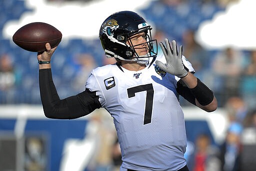 FILE - In this Nov. 24, 2019, file photo, Jacksonville Jaguars quarterback Nick Foles warms up before an NFL football game against the Tennessee Titans in Nashville, Tenn. A person familiar with the trade says the Jacksonville Jaguars have agreed to send quarterback Nick Foles to the Chicago Bears for a compensatory fourth-round draft pick. The person spoke to The Associated Press on condition of anonymity because trades don't become official until the league year begins later Wednesday, March 18, 2020. (AP Photo/Mark Zaleski, File)